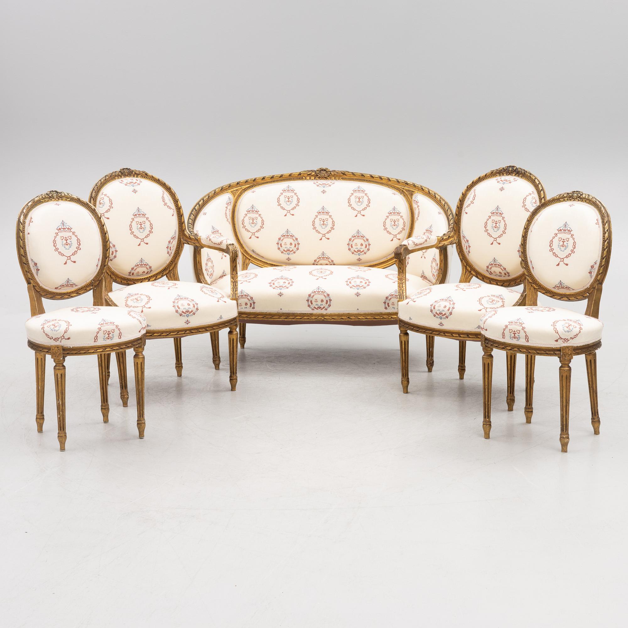 A Gustavian style sofa with two armchairs and two chairs, 20th century.
