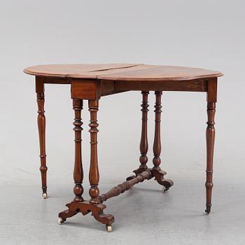 A neo-renaissance mahogany drop-leaf table from secord half of 19th century.