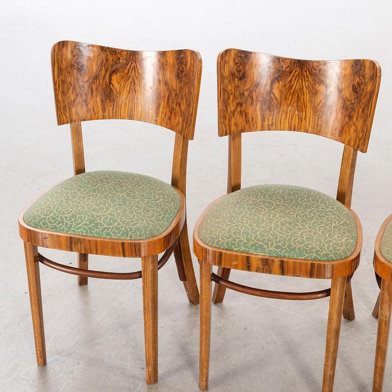 A set of four mid 20th century chairs in walnut.