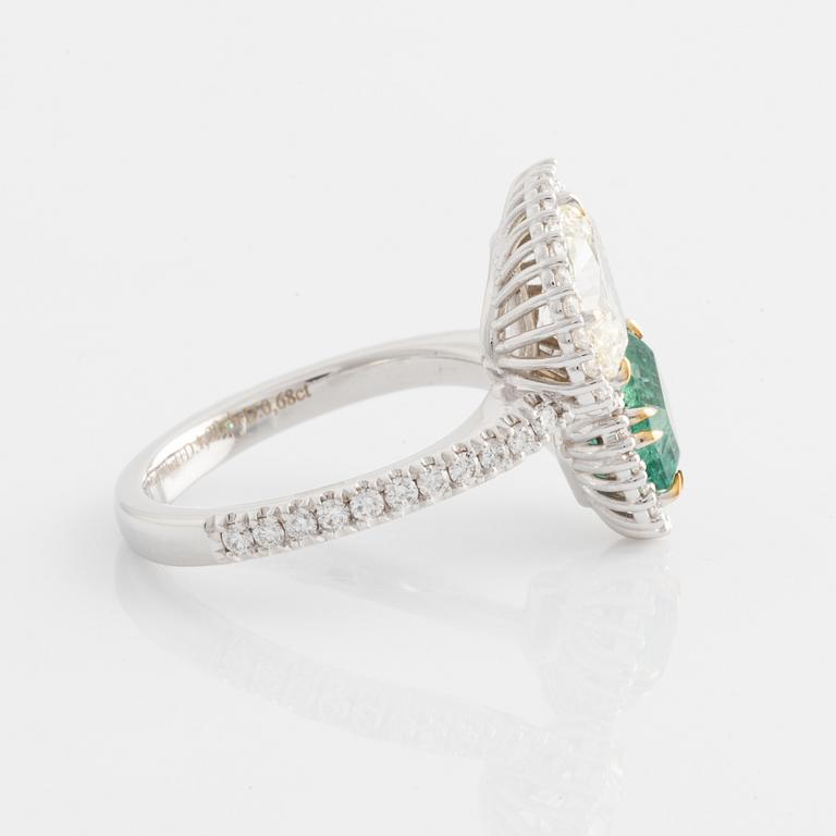 Ring with emerald-cut emerald and pear-shaped diamond, accompanying GIA diamond report.