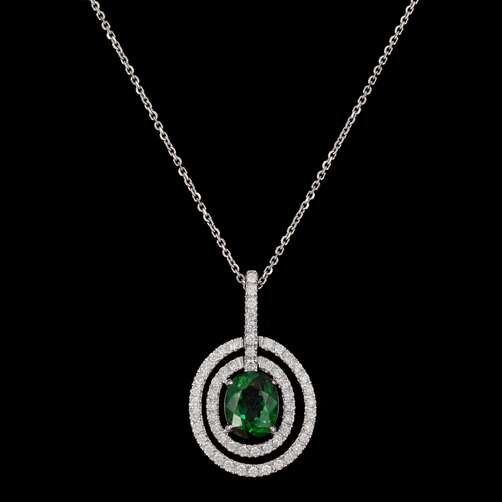 PENDANT, oval cut green tourmaline and brilliant cut diamonds, tot. 0.53 cts.