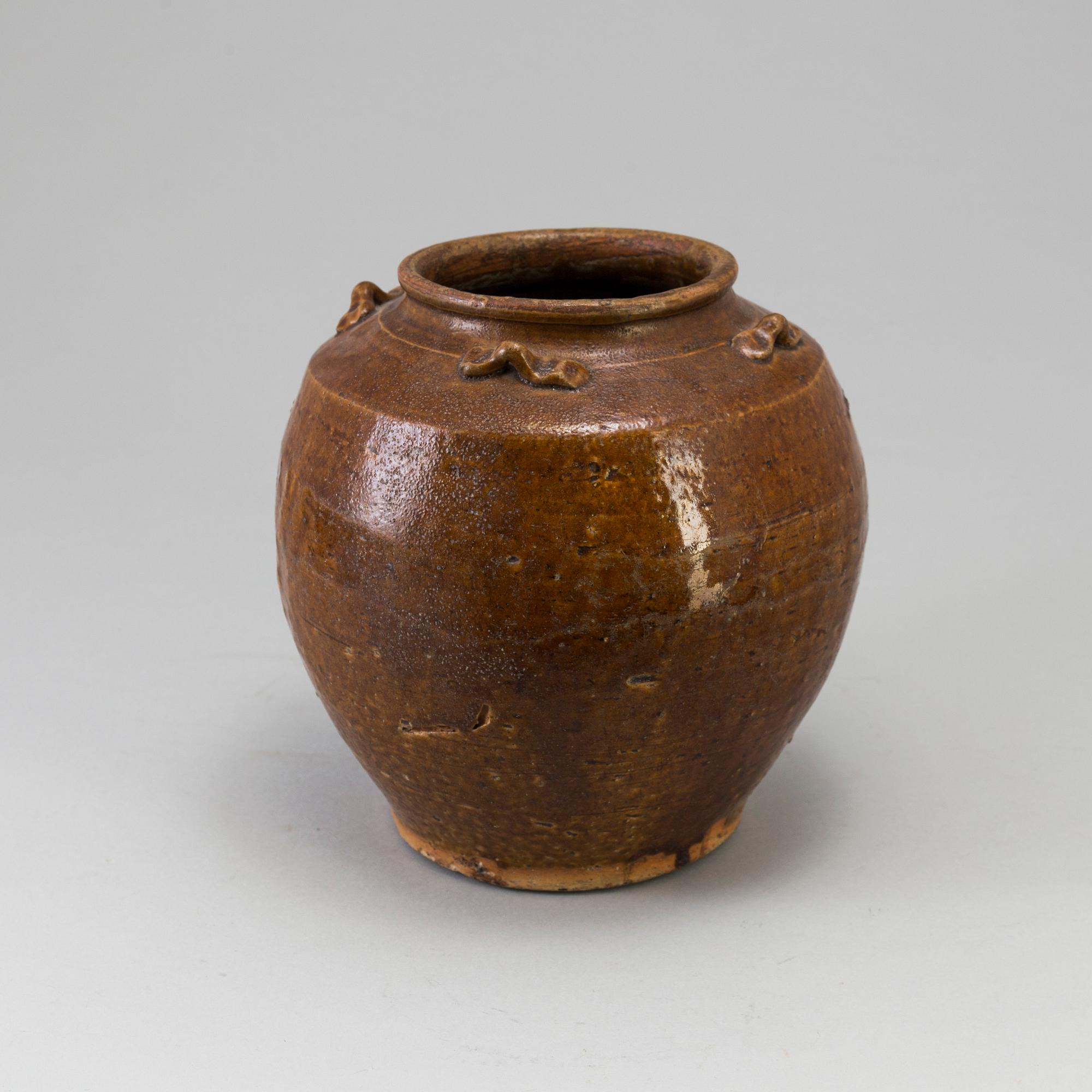 A south east asian pottery urn 18/19th century.