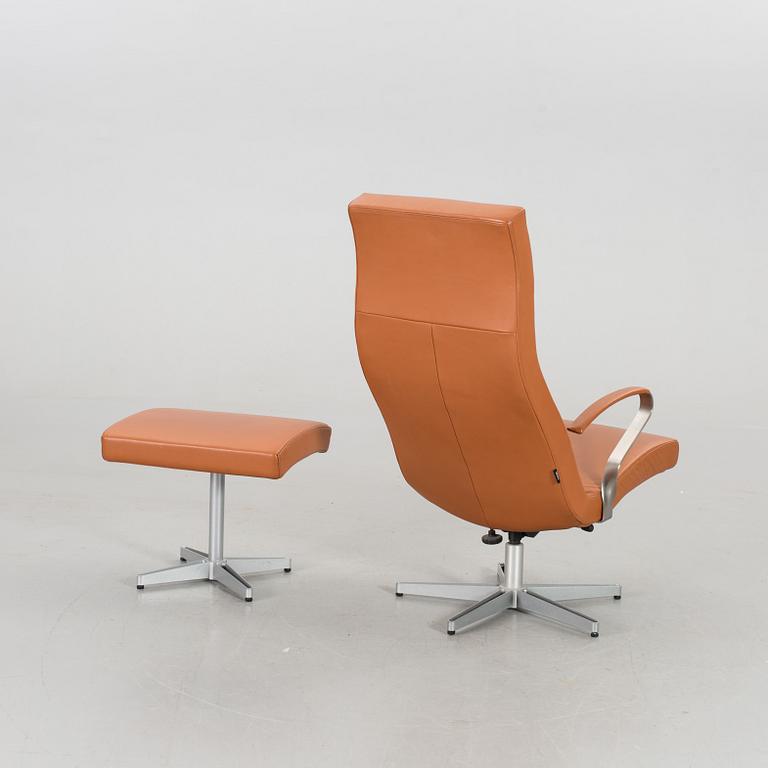 AN ARMCHAIR WITH STOOL MODEL "TWIST" DESIGNED BY JERKER ANDERSSON FOR SÖDERBERGS MÖBLER.