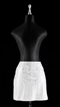 A white macintosh with skirt by Chanel.