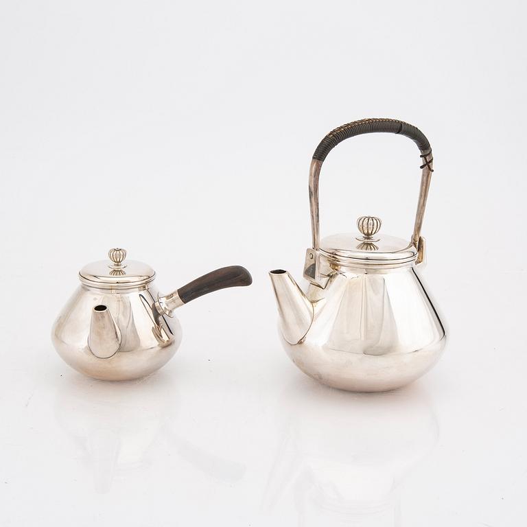 A set of two Japanese early 20th century sterling silver tea pots weight 474 grams.