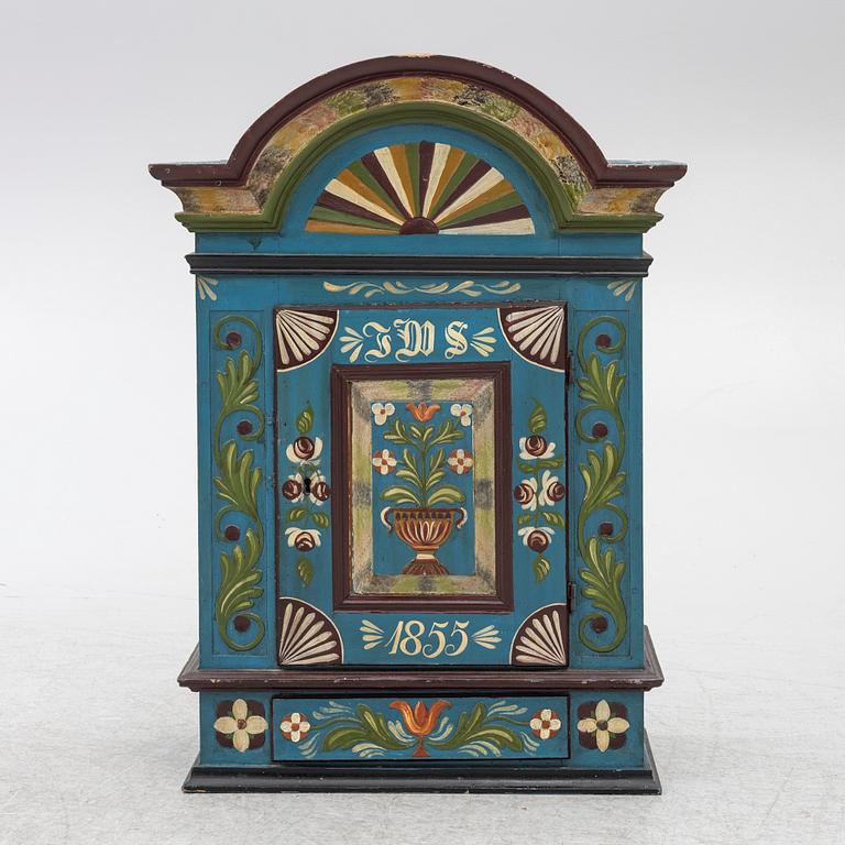 A 19th century folk art hanging cabinet.