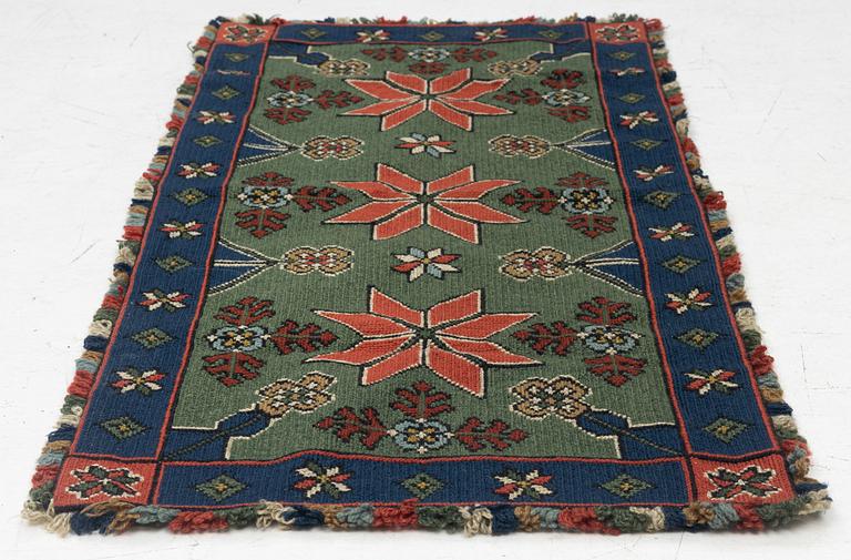 A Scania cross-stitch embroidered cushion, Sweden, around 1900, c. 99 x 47 cm.