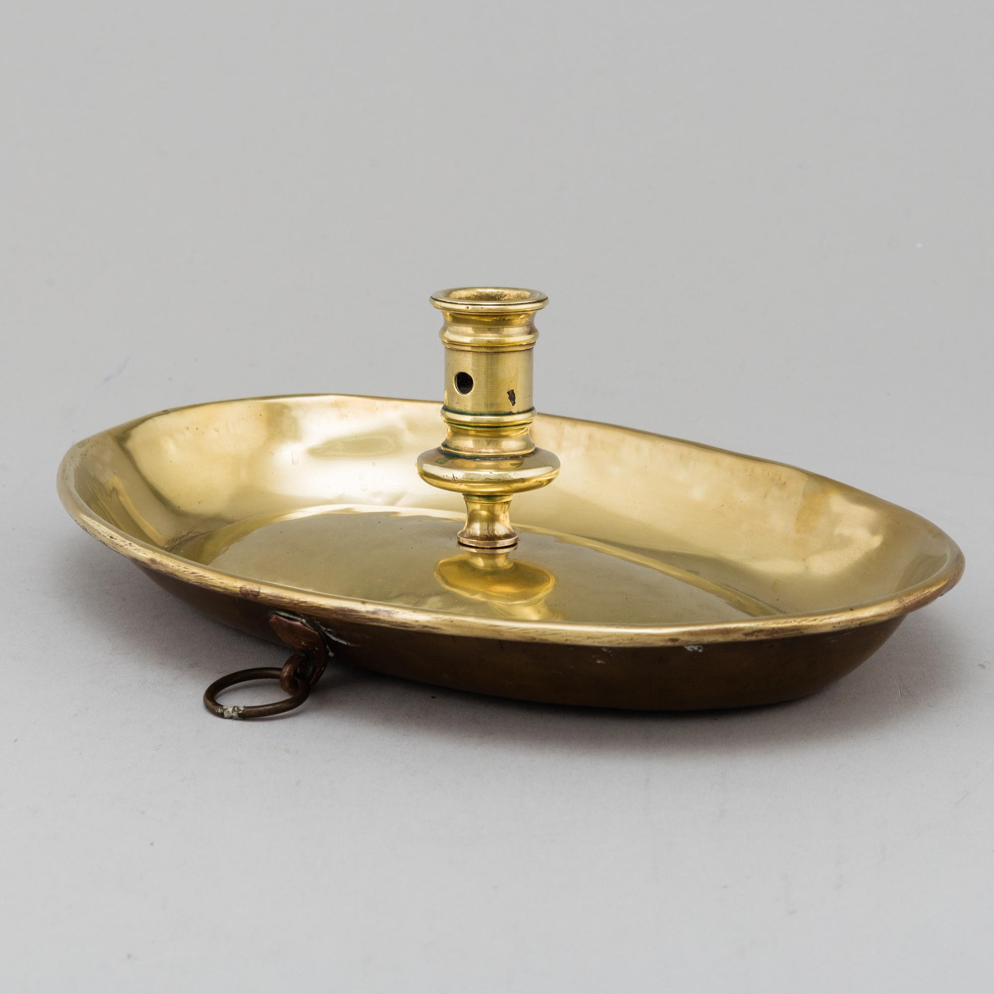 An 18th century brass candlestick.