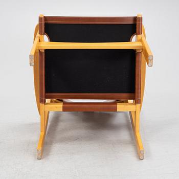 Carl-Axel Acking, a pair of oak and brown natural leather 'Trienna' chair, Nordiska Kompaniet, Sweden.