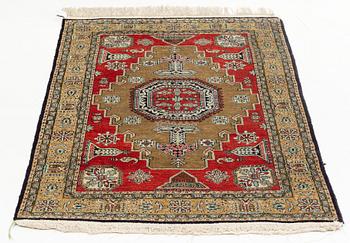 A rug, silk Quum, ca 121 x 76 cm.