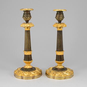 A pair of ormolu late empire candlesticks, mid 19th century.