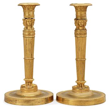 679. A pair of French Empire early 19th century candlesticks.