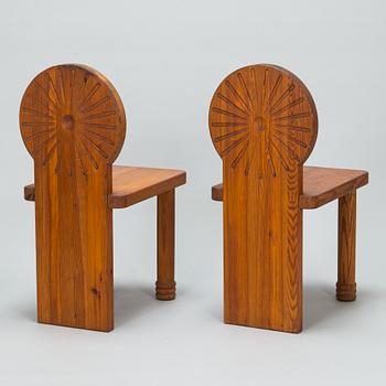 A pair of 1970s pine wood chairs.