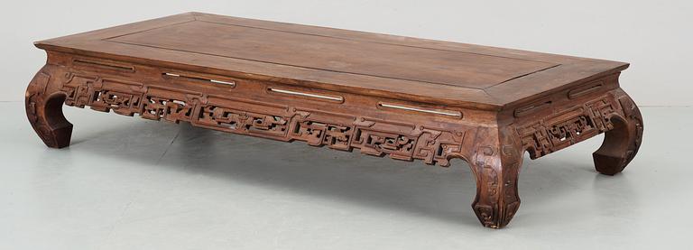 A wooden Chinese low table, 20th Century.