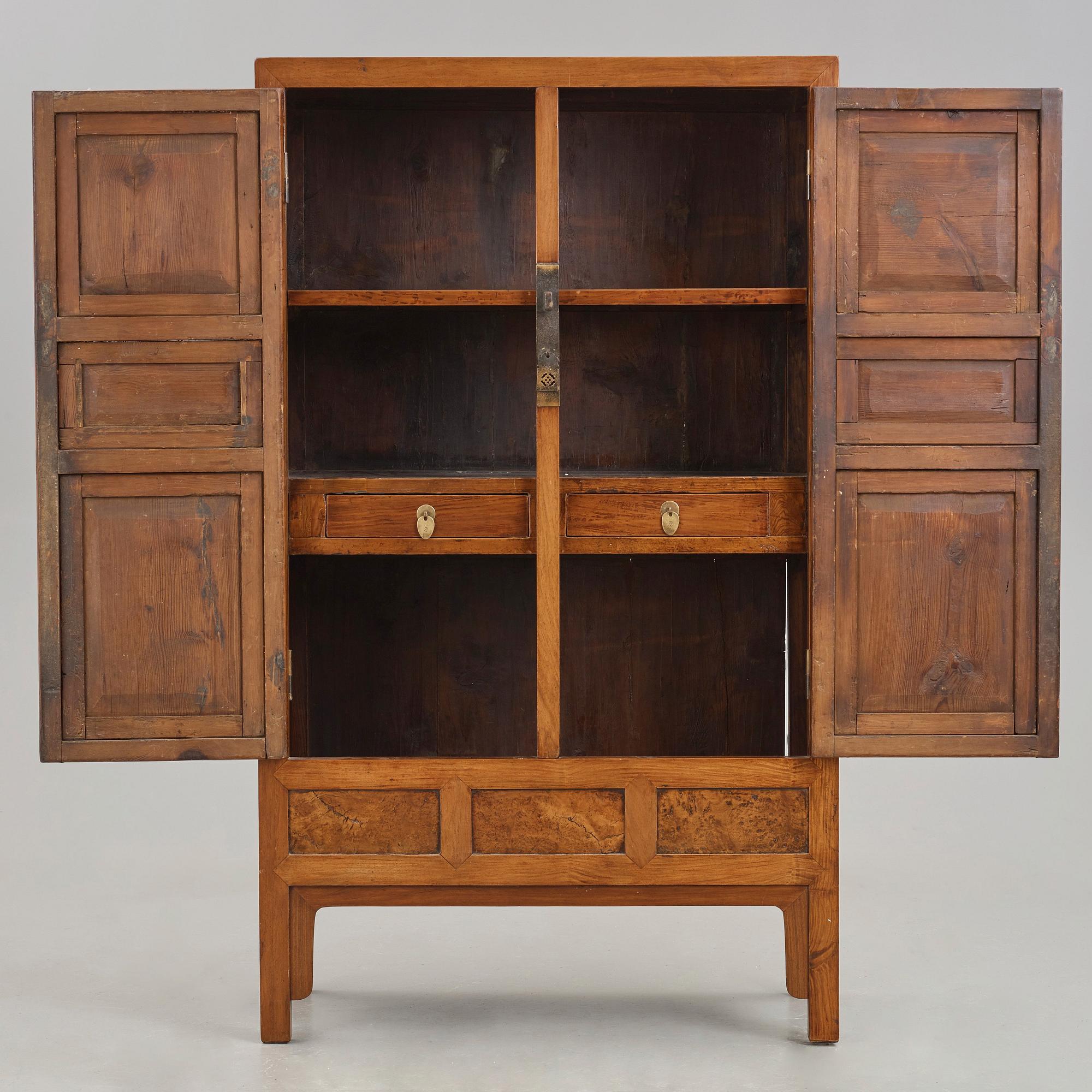 A huanghuali veneered, huamu and mixed wood cabinet, 19th century, Qing dynasty, 19th Century.