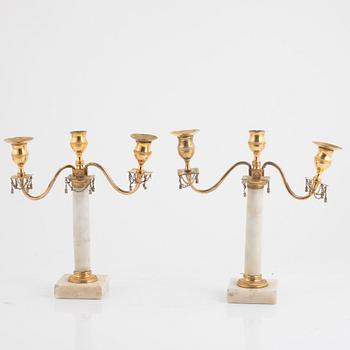 A pair of late Gustavian three-light white marble and gilt brass candelabra, late 18th century.