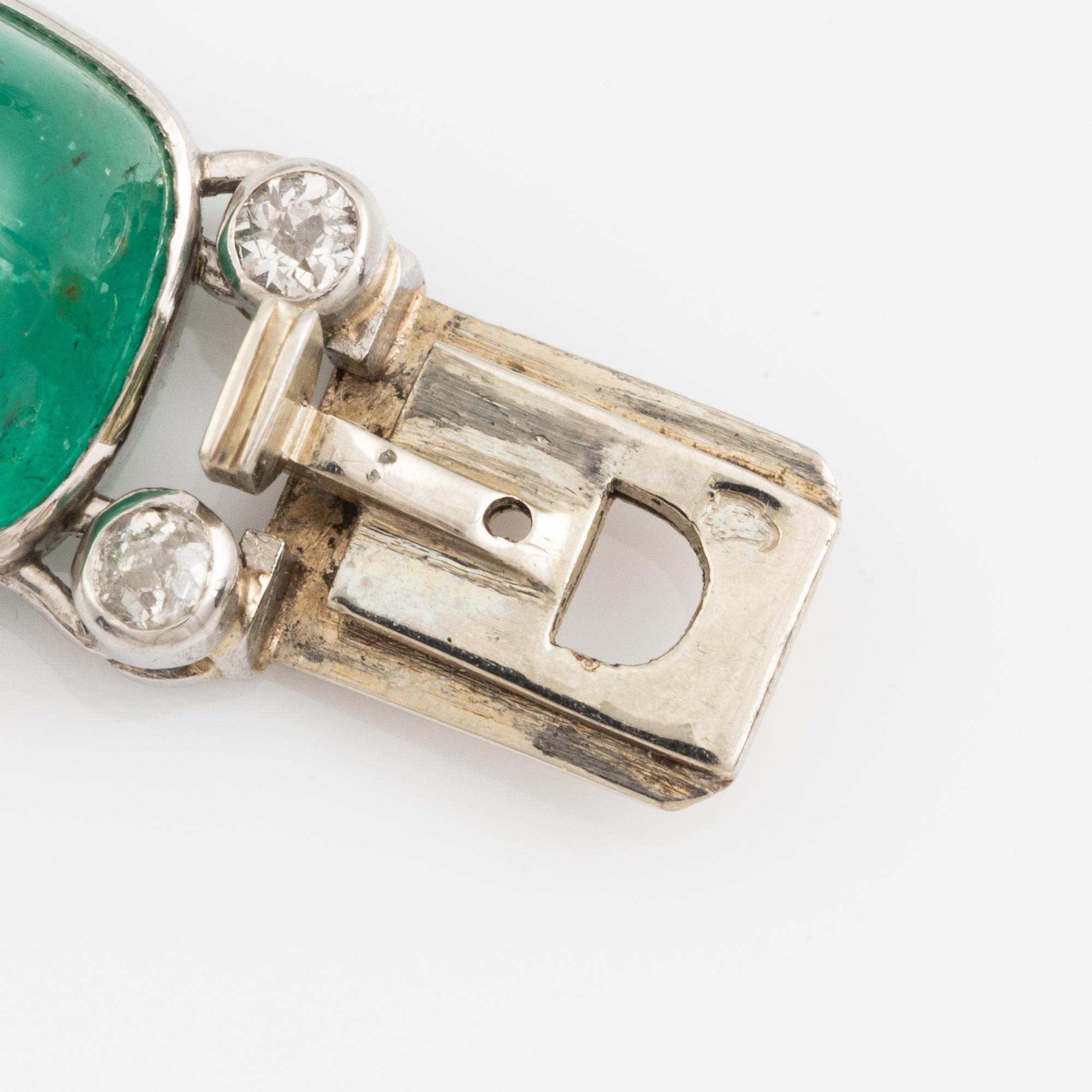 An art deco platinum necklace/bracelet combination with cabochon-cut emeralds.