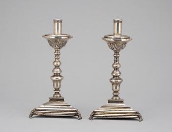 A pair of possebly Spanish or South American 18th century candelsticks, unidentified makers mark.