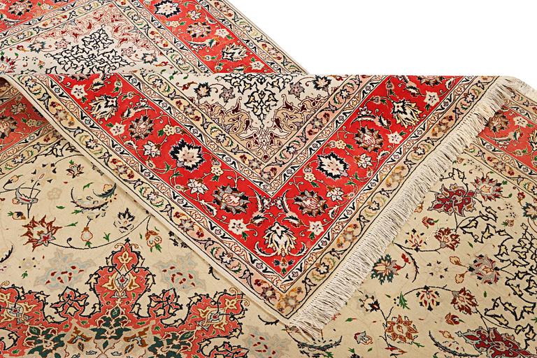 A Tabriz, part silk carpet, c. 300 x 199 cm.