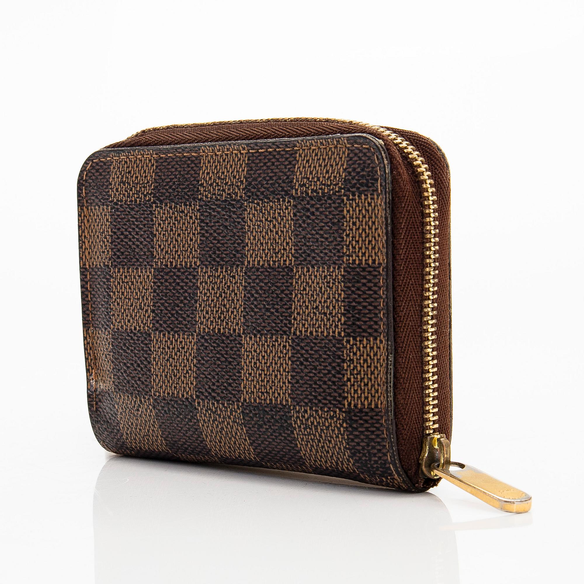 Louis Vuitton, a 'Zippy Coin Purse' wallet and an 'Inventeur' belt.