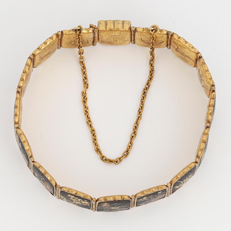 ARMBAND, gul metall med japanskt motiv.