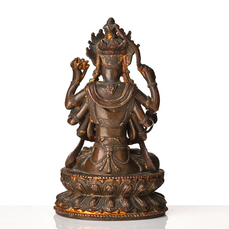 A cold gilt copper alloy figure of eight armed Boddhisattva Avalokiteshvara, late Ming dynasty.