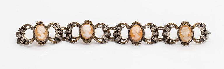 A silver and sea shell cameo bracelet.