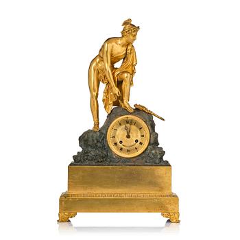 140. A French Empire ormolu and patinated bronze mantel clock, Paris, early 19th century.