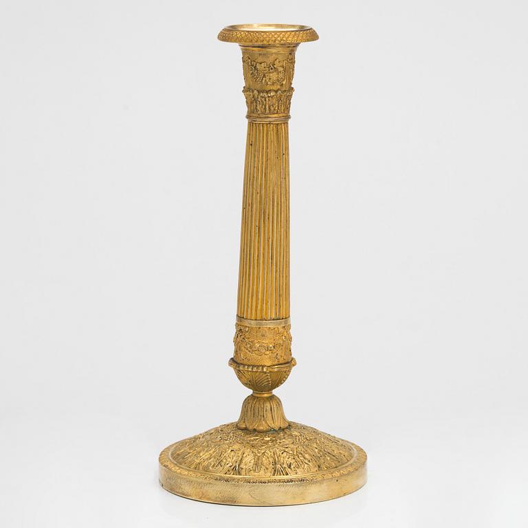 An Empire style gilded bronze candlestick, first half of the 19th century.