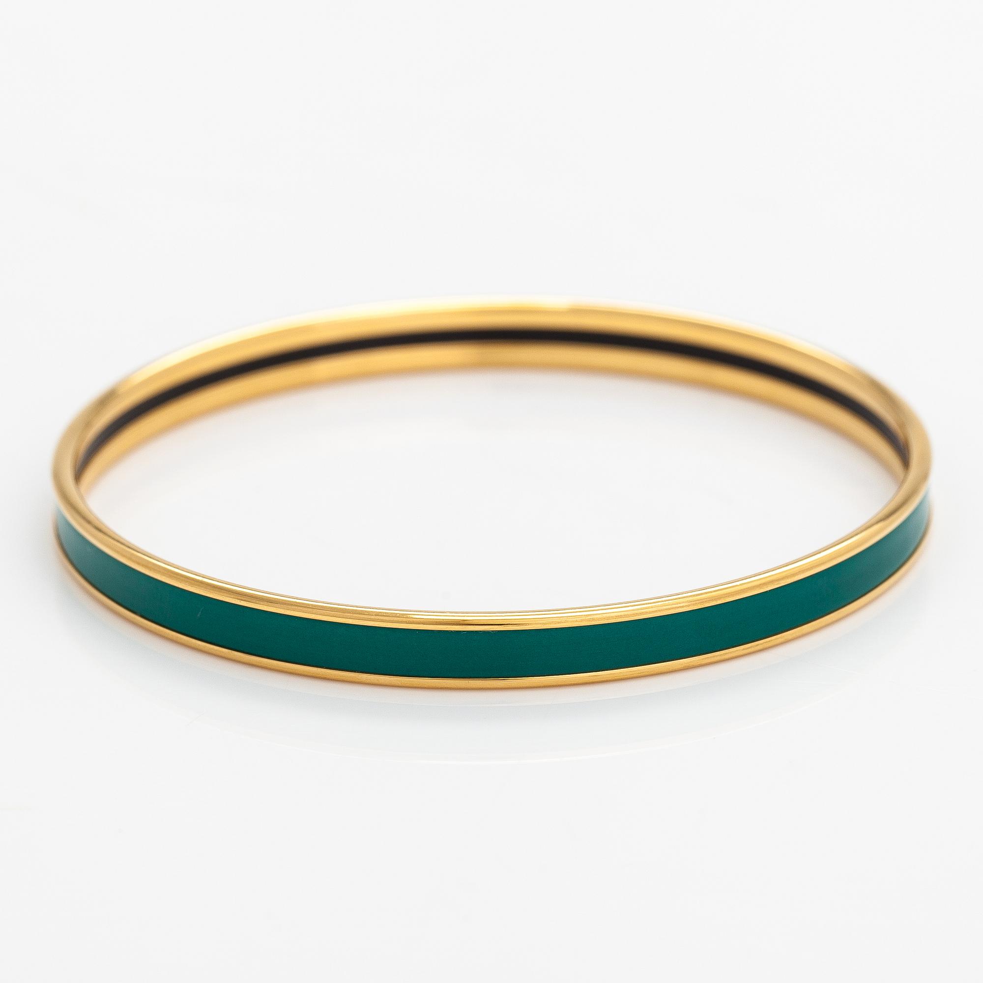 Hermès, a bracelet made of gold coloured metal and green enamel. Marked Hermès Paris, Made in France.