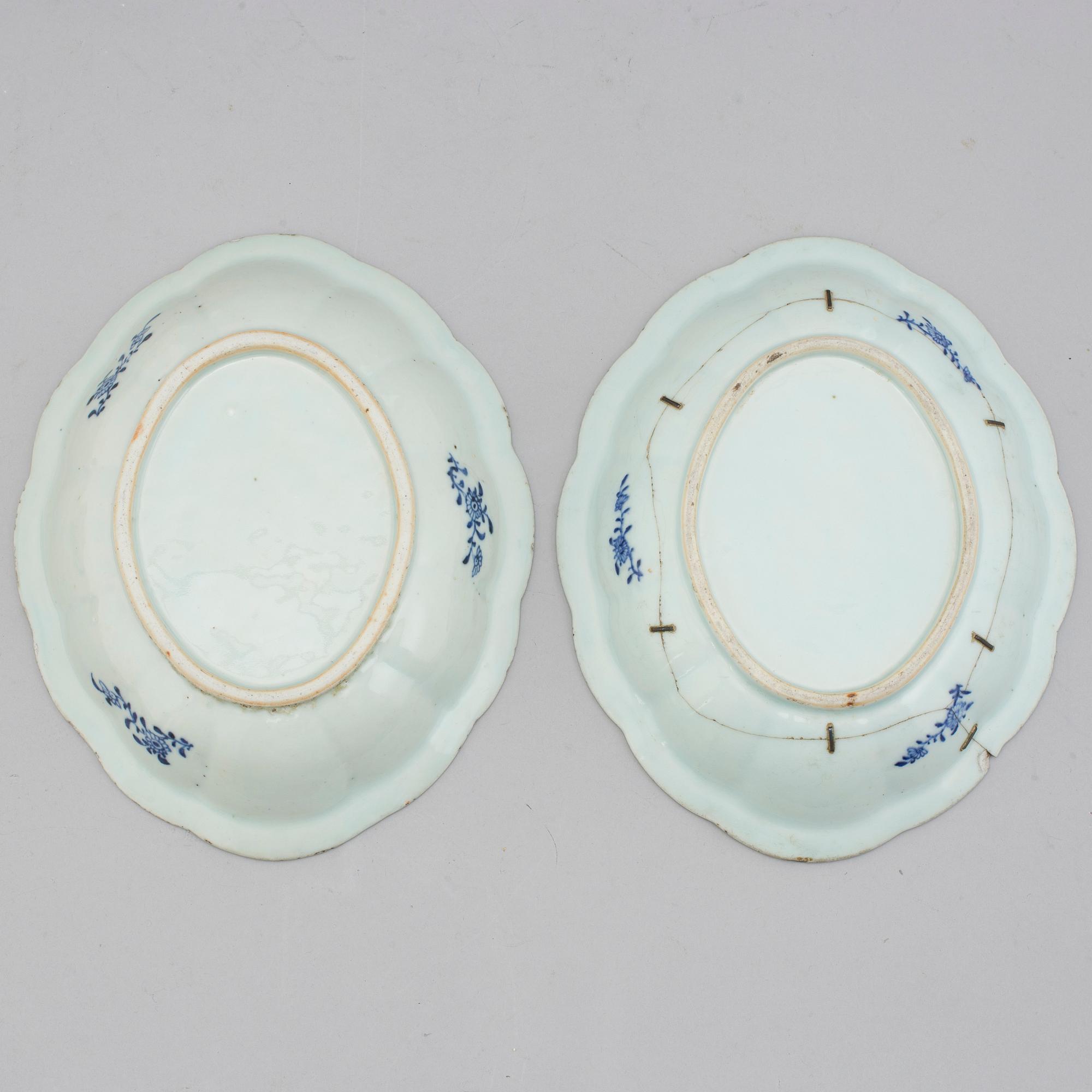 Two blue and white export porcelain tureens with covers and three dishes, Qing dynasty, 18th century.