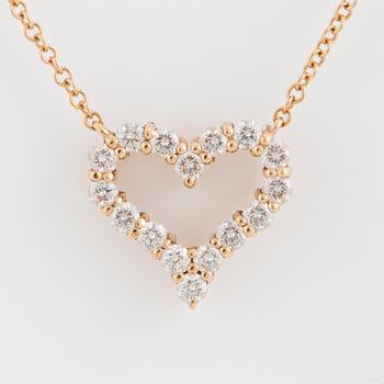 A Tiffany heart pendant in 18K rose gold set with round brilliant-cut diamonds.