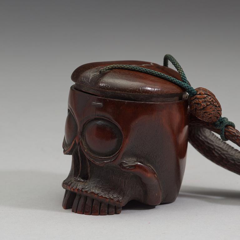 A Japanese bamboo box in the form of a skull with snake, Meiji period (1868-1912).