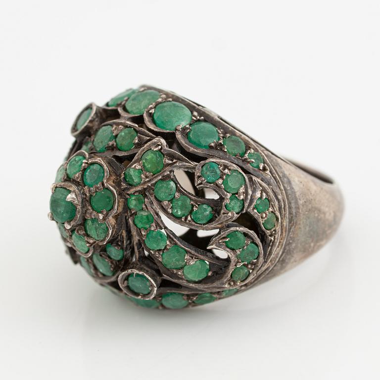Silver ring with green stones.