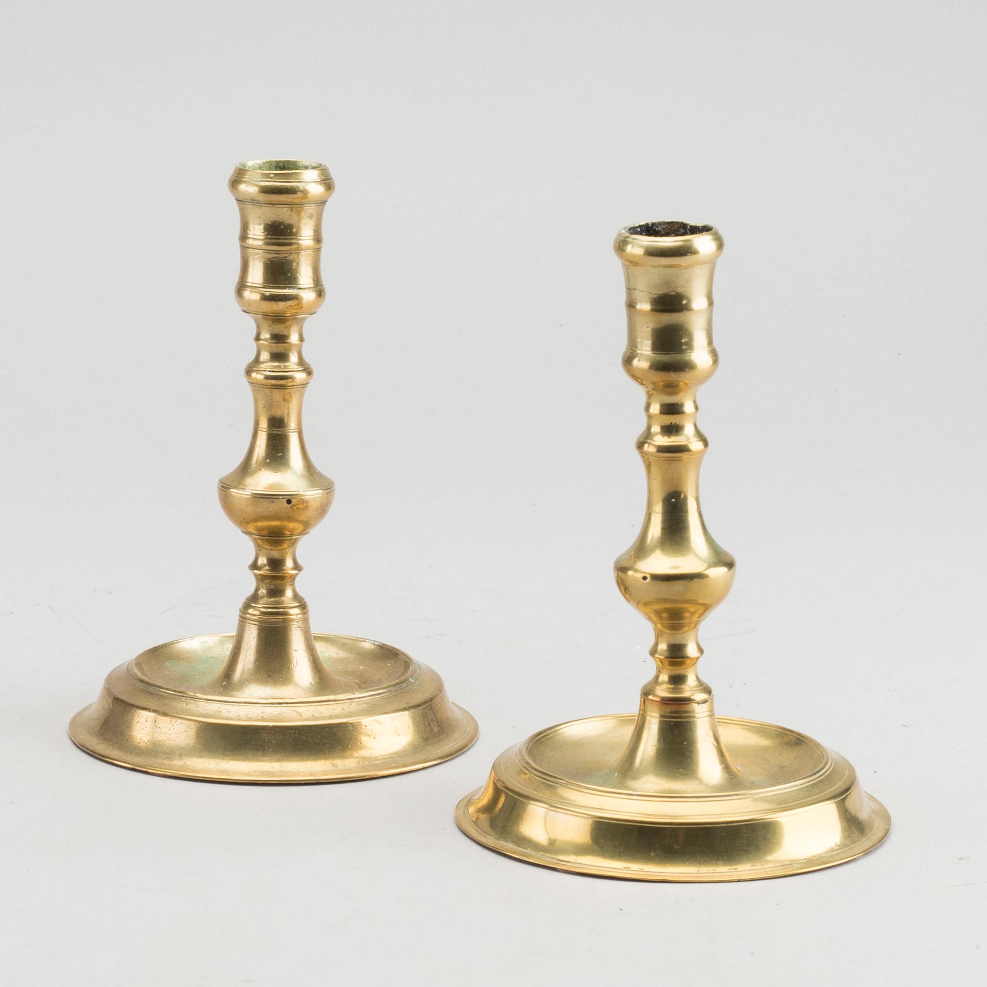 A set of two of brass candle sticks mid 18th century.