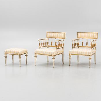 A pair of late Gustavian-style open armchairs and a stool, circa 1900.