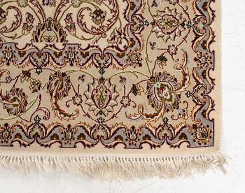 An Isfahan, part silk rug, signed, c. 165 x 112 cm.