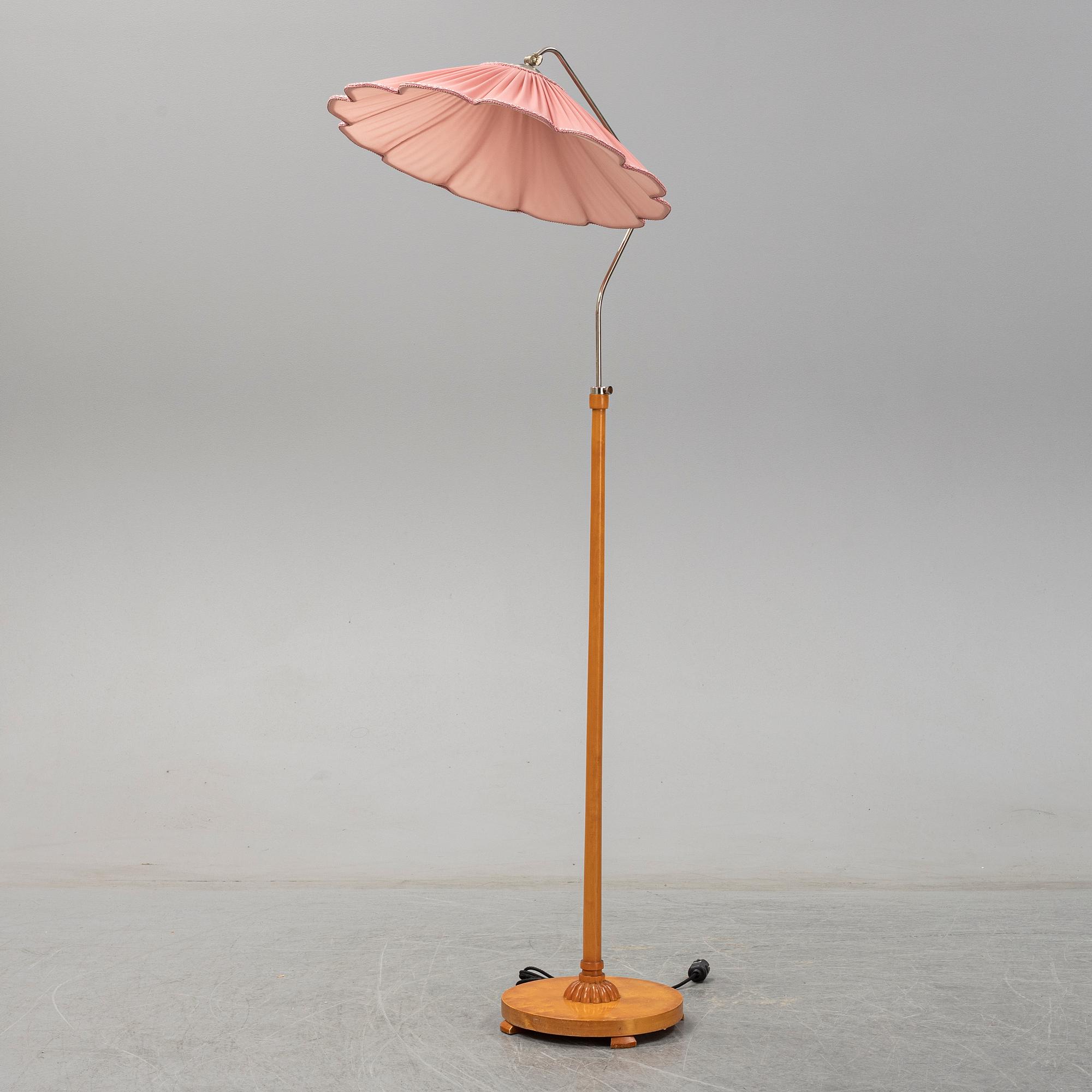 A 1940s birch wood floor lamp.