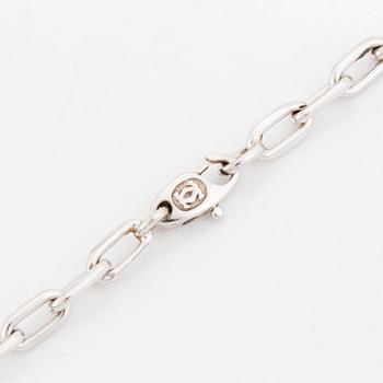 An 18K gold and white gold Cartier necklace with a charm.