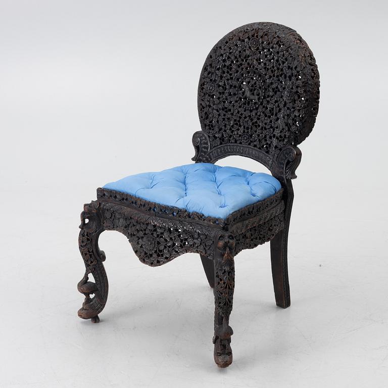 A carved 'blackwood' armchair.  bombay presidency circa 1880.