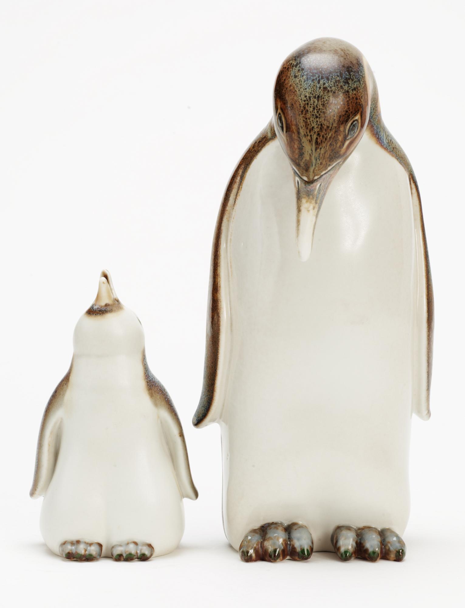 Two Gunnar Nylund stoneware figures depicting a penguin mother with child, Rörstrand.