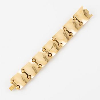 A bracelet 18K gold with enamel details.