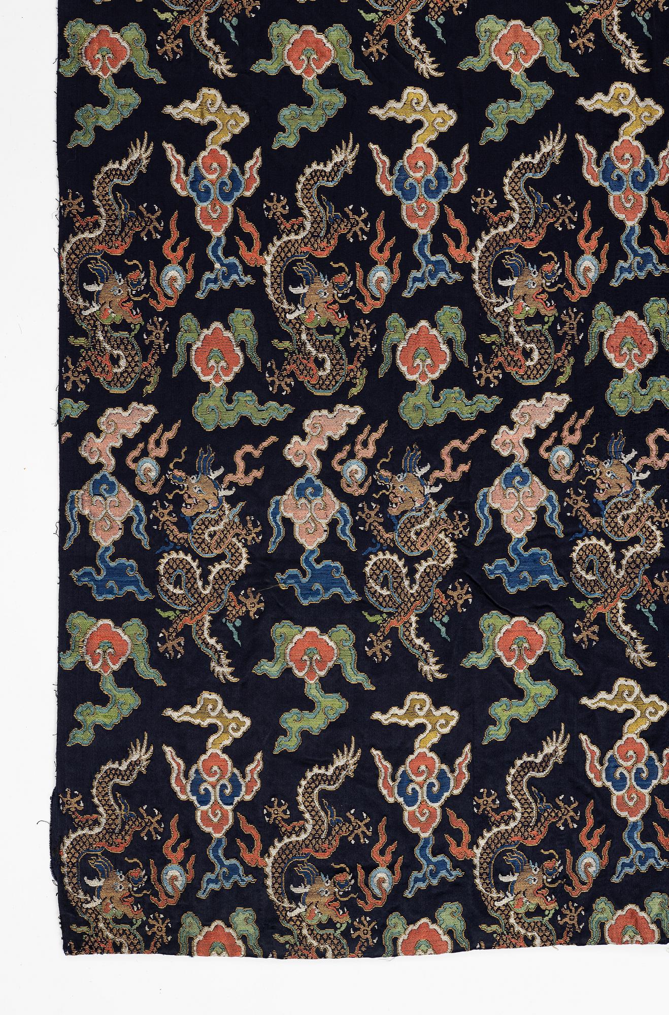 A set of three bolts of silk with 'five clawed dragons' against a midnight blue ground, Qing dynasty, 19th century.