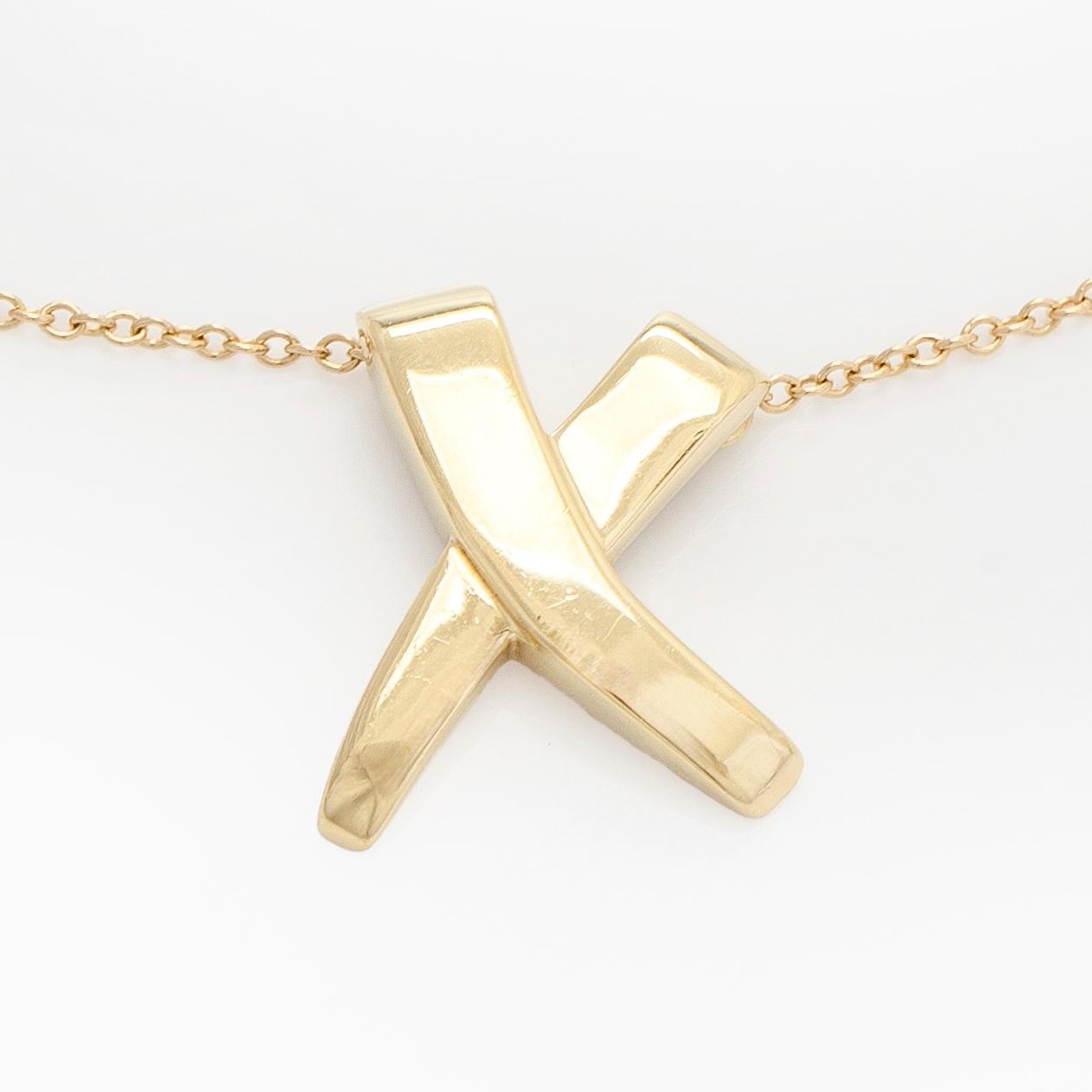 Tiffany & Co, Paloma Picasso, an 18K gold "X Kiss" necklace.