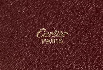 A bordeaux leather brief-case by Cartier.