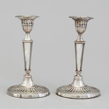 HARRISON BROTHERS & HOWSON, a pair of silver and mother of pearl candlesticks from Sheffield, England, 1926.