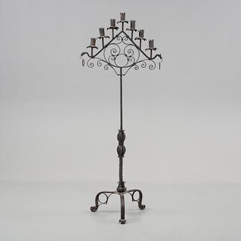 A metal floor candelabra, first half of the 20th century.