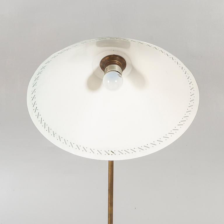 A 1950s brass floor lamp.