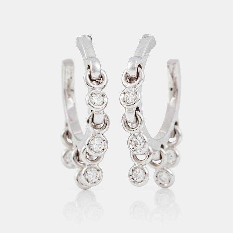 A pair of Dior white gold hoop earrings with 5 suspending brilliant-cut diamonds on each earring.