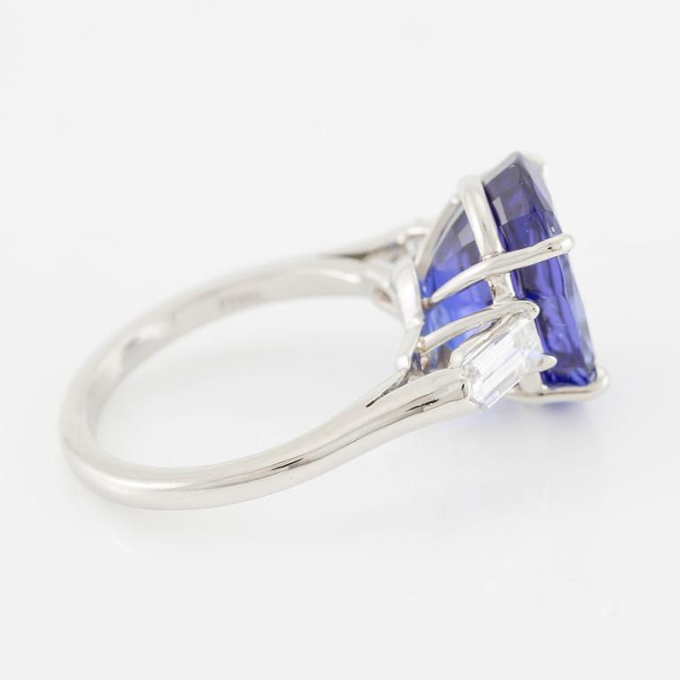 Ring, Fred Leighton platinum with an oval faceted tanzanite and fancy-cut diamonds.
